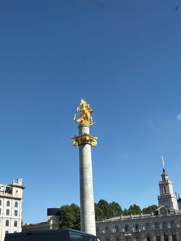 Tbilisi's Freedom Monument under a clear blue sky