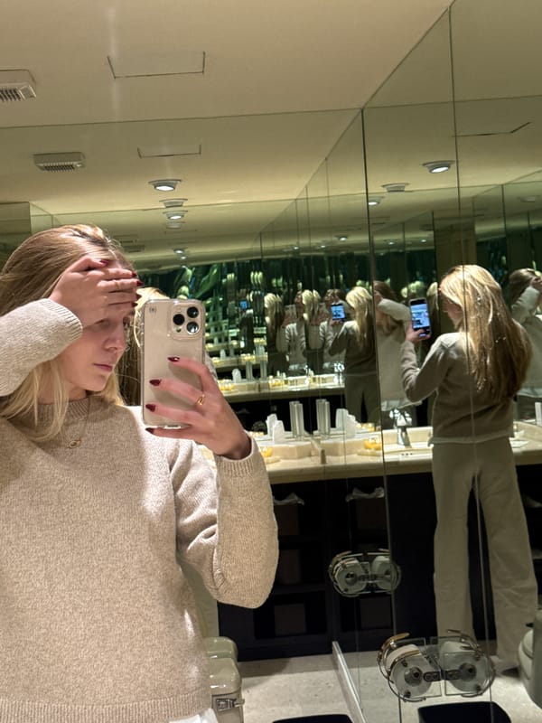 Woman takes mirror selfie in candlelit bathroom in Mexico City