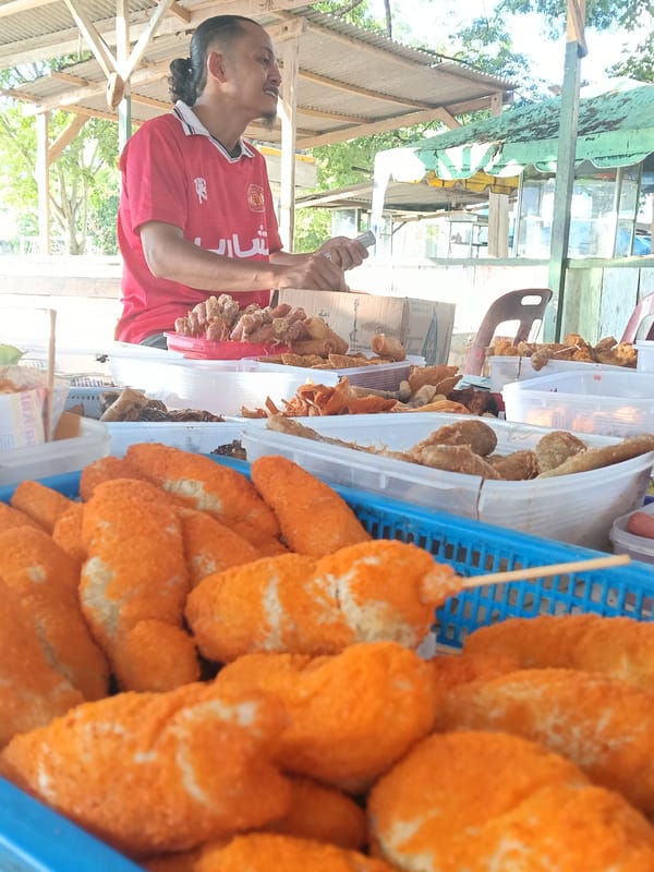 Street vendor operates food cart near Islamic school in Lhokseumawe