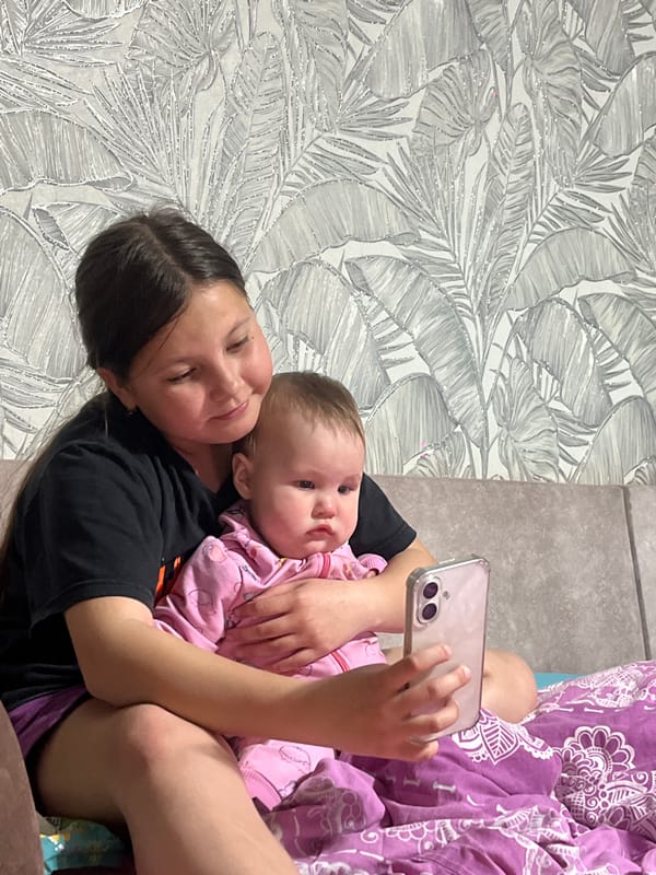 Girl takes selfie with baby in Novopokrovskaya, Russia