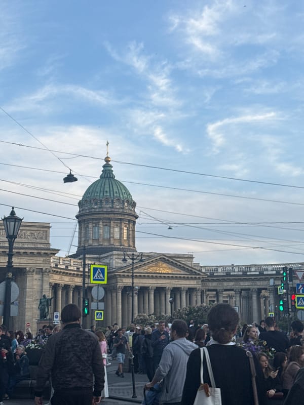 Evening street life unfolds around Saint Petersburg's historic landmarks