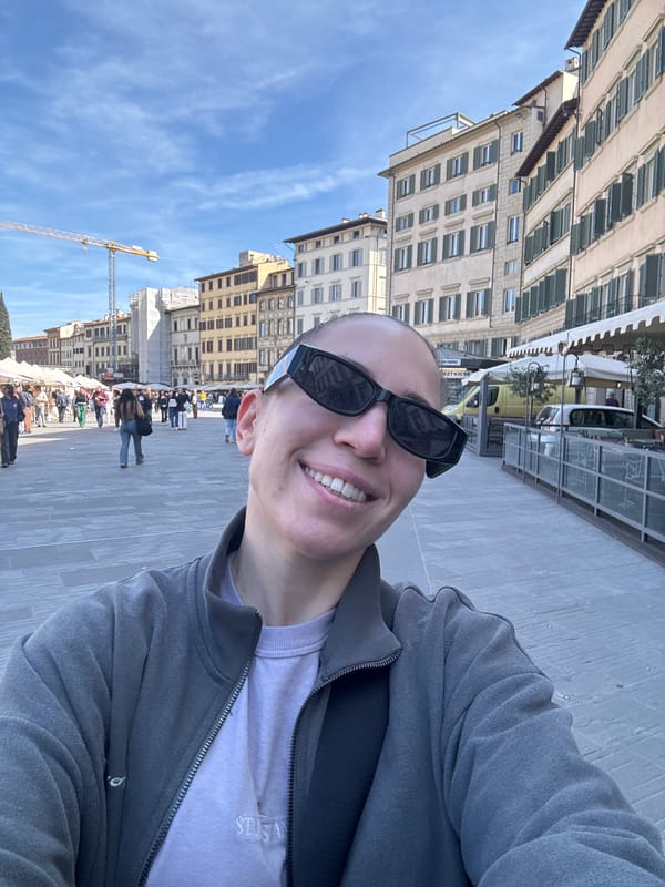 Tourist takes selfie in bustling Florence public square