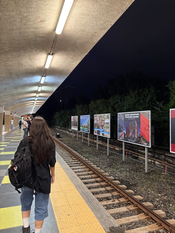 Tbilisi at night: wet streets, buses, and city lights
