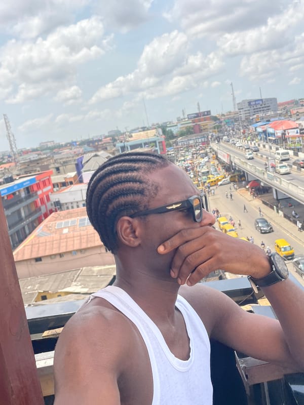 Man takes selfies from rooftop overlooking busy Ikeja cityscape