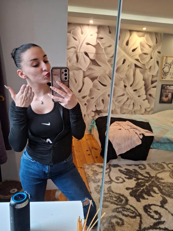 Woman takes mirror selfies in bedroom in Buhovo Bulgaria