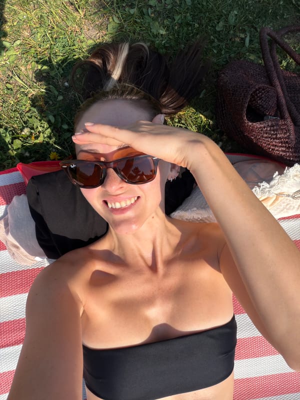 Woman sunbathes in park during early morning in Khimki