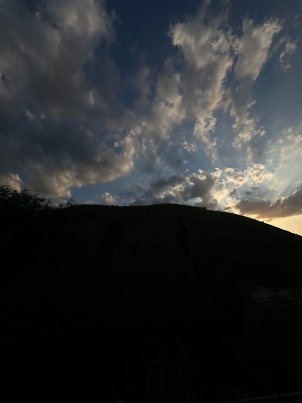 Hillside park visit in Almaty under a dramatic evening sky