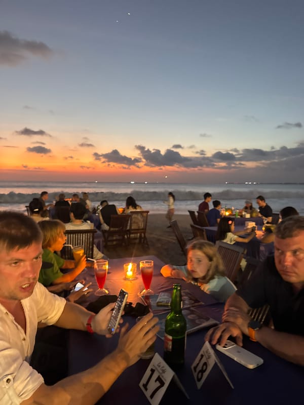 Beachside sunset dining scene unfolds in Kuta Selatan, Indonesia