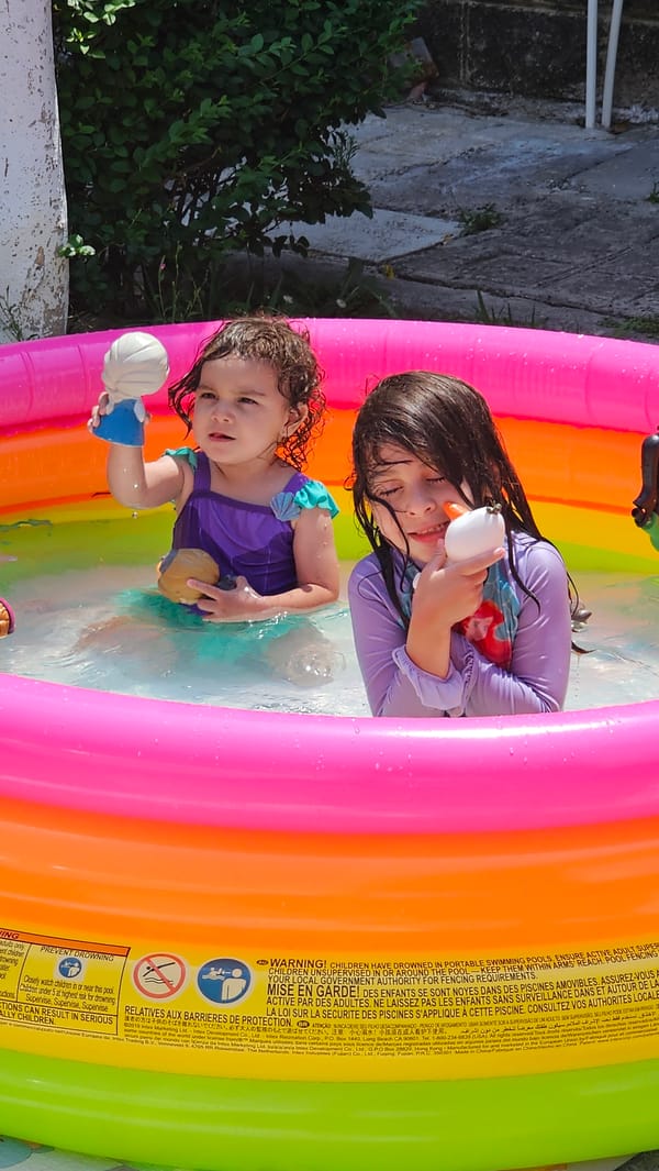 Children play in inflatable pool in Mexican backyard