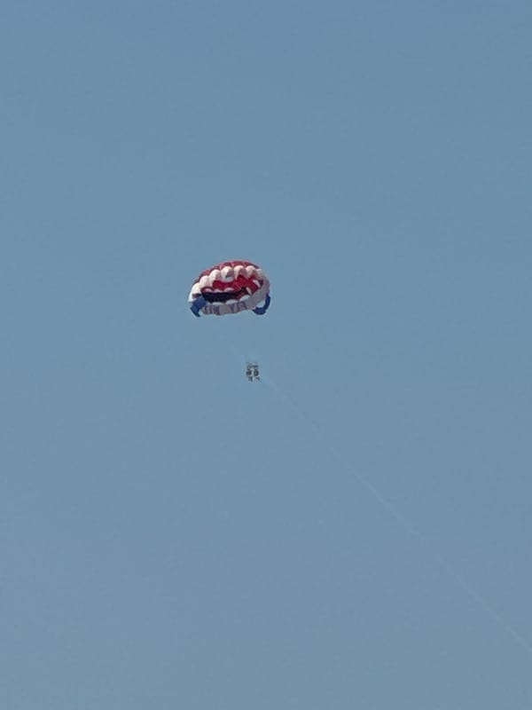 Colorful parachute drifts through the sky above Budva, Montenegro