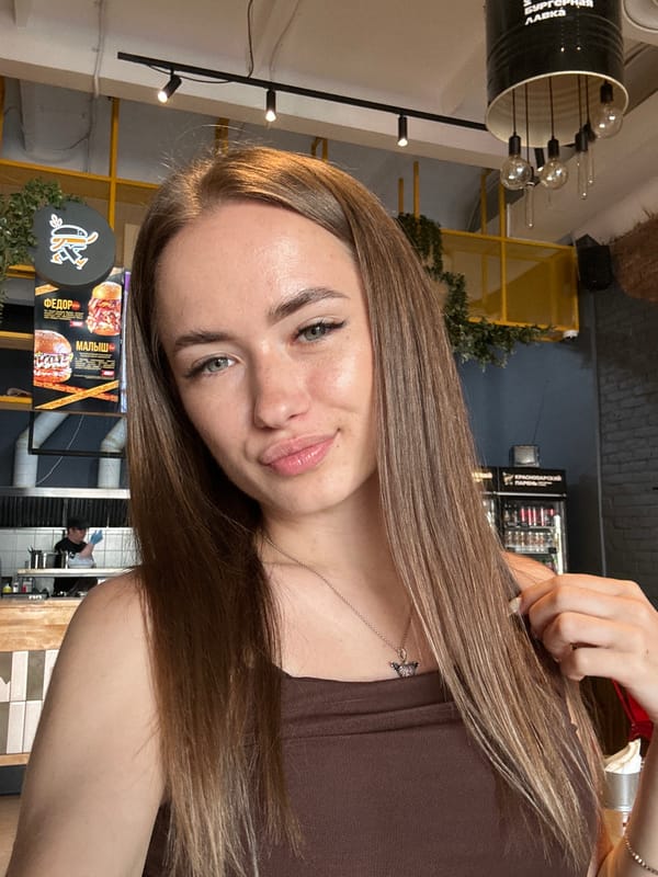 Woman documents restaurant meal with selfies and food photos