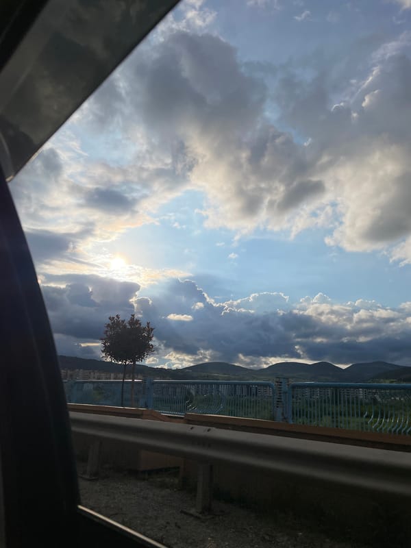 Driver documents cloudy afternoon sky, parked BMW in Kardzhali