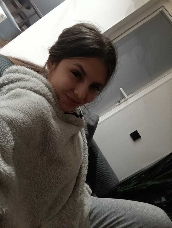 Woman takes indoor selfies in gray outfit, Russia