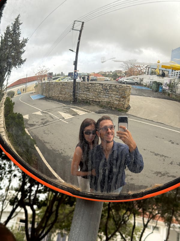Couple takes selfies on cobblestone street in Cyprus village