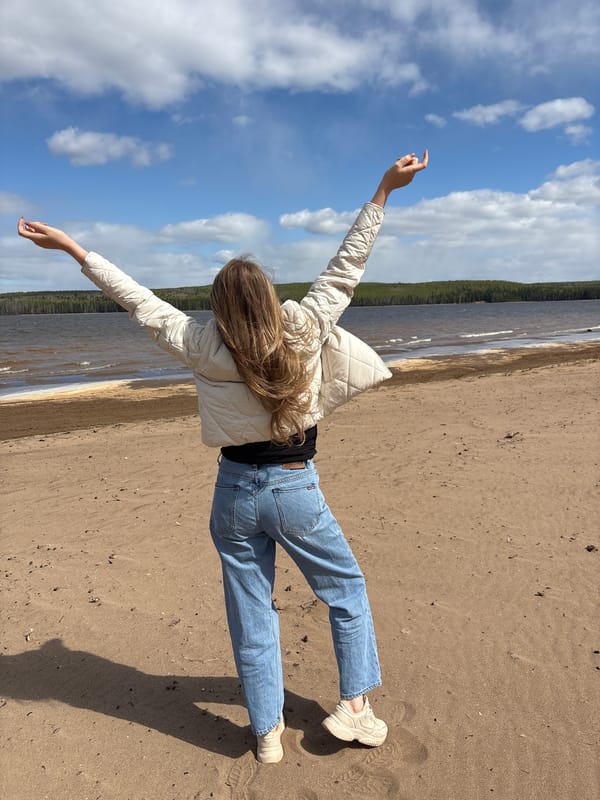 Woman enjoys morning beach visit at Kama Reservoir, Russia