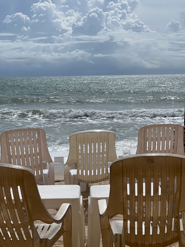Empty beach furniture documented under cloudy skies Sunday morning