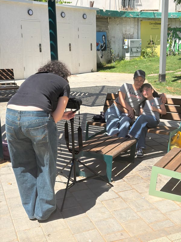 Photographer sets up shoot for relaxed couple in Tel Aviv