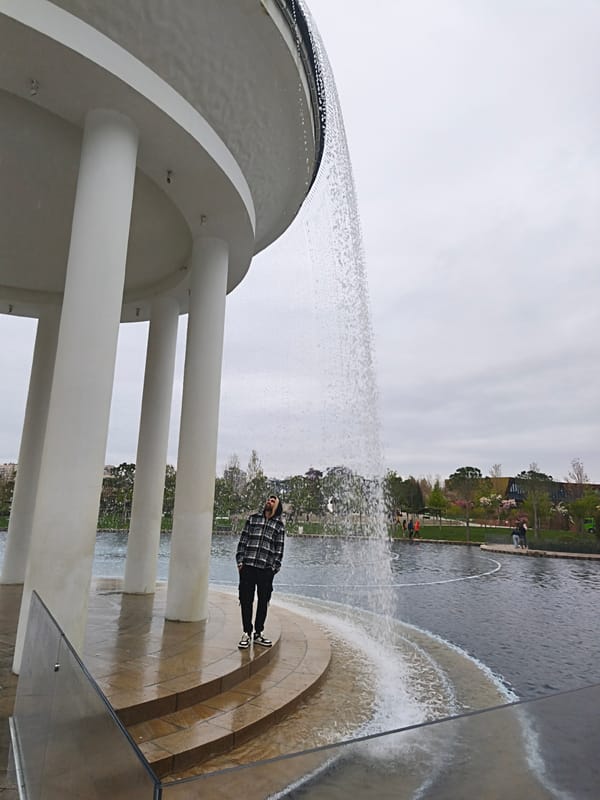 Visitor explores Krasnodar park featuring sculptures, fountains, digital displays
