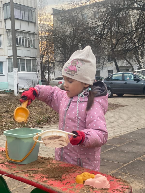 Child plays in sandbox at Chaikovsky playground