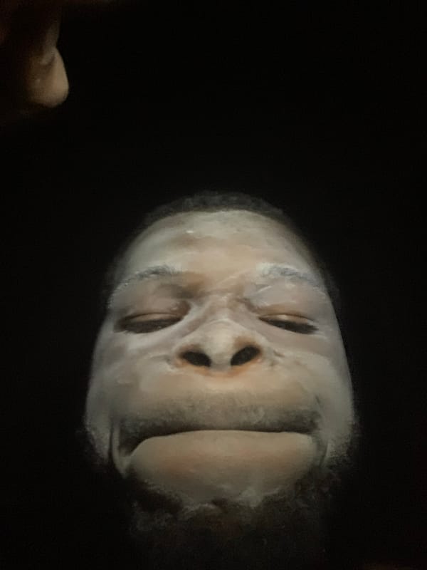 Person applies white face mask in Onitsha Nigeria