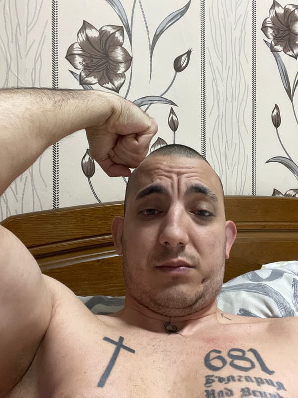 Tattooed man photographed indoors in Sofia residence