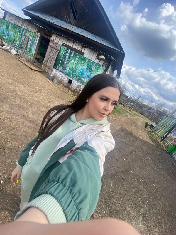 Woman documents farm visit with animals in rural Russia