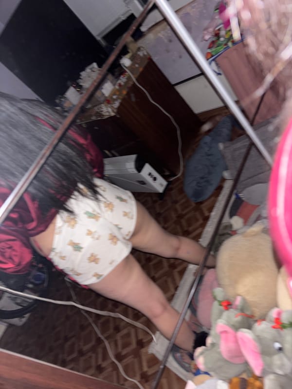 Person in teddy bear pajamas shows 'Blessed by God' tattoo