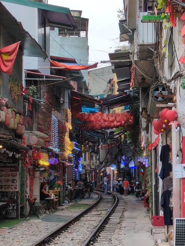 Hanoi's famous train street, tracks cutting through a busy urban corridor