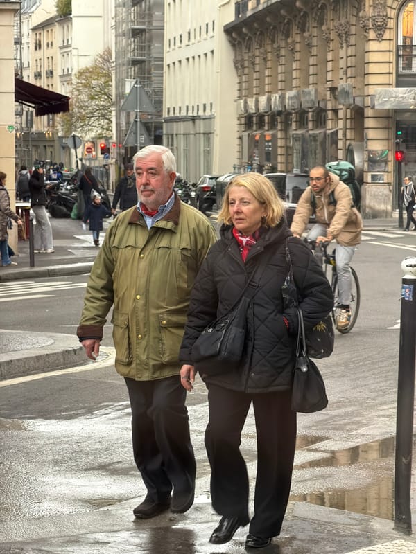 Pedestrians navigate wet Paris streets on March afternoon