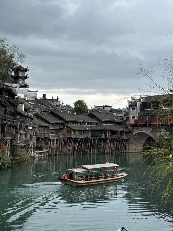 Tourists pose in traditional costumes at Fenghuang Ancient Town