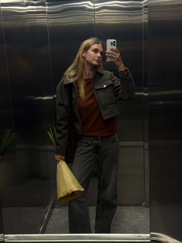 Woman takes flower bouquet selfie in Tbilisi elevator