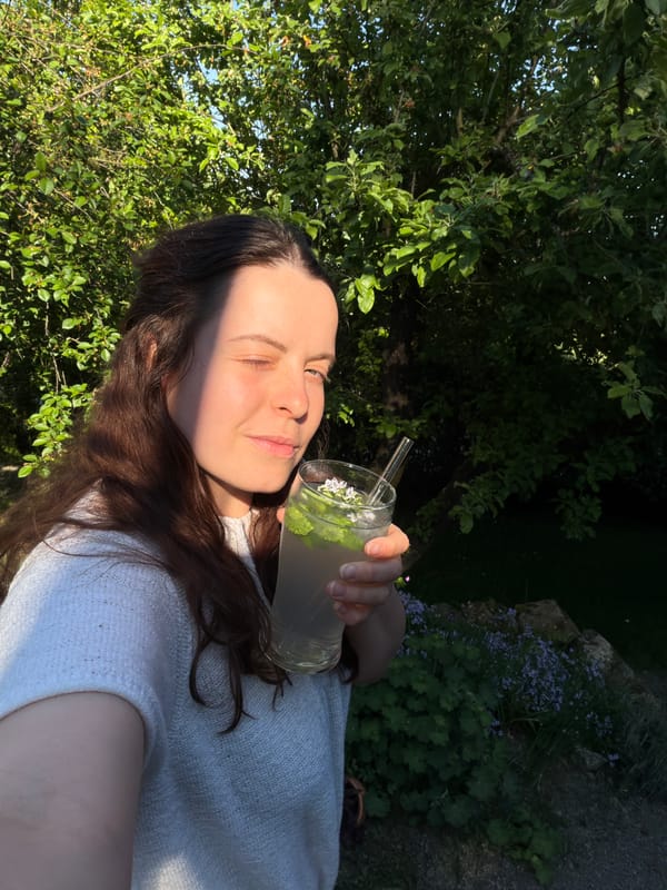 Woman enjoys refreshments and ice cream in German village
