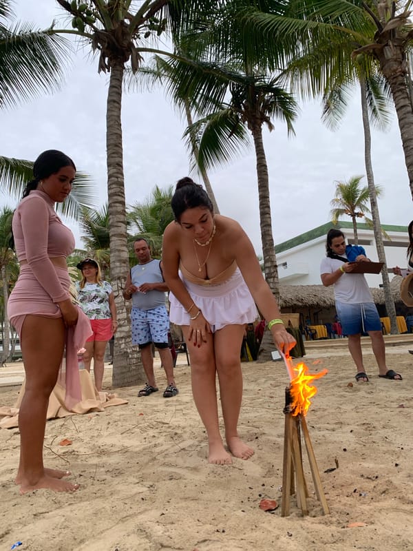 Evening beach gathering with torches in El Tirano, Venezuela