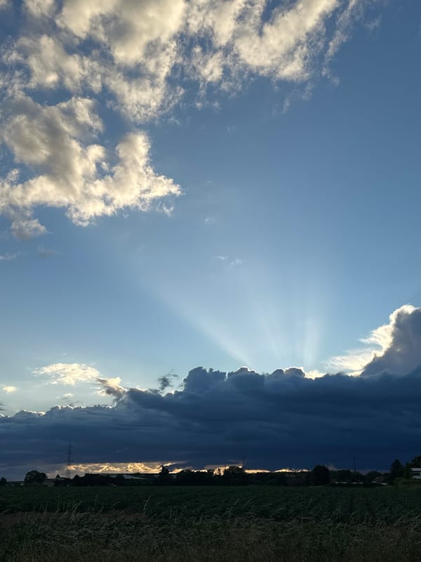 Dramatic sunbeams pierce storm clouds over rural Krefeld Germany