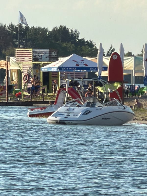 Summer lake afternoon: jet skis, paddleboards, and golden hour