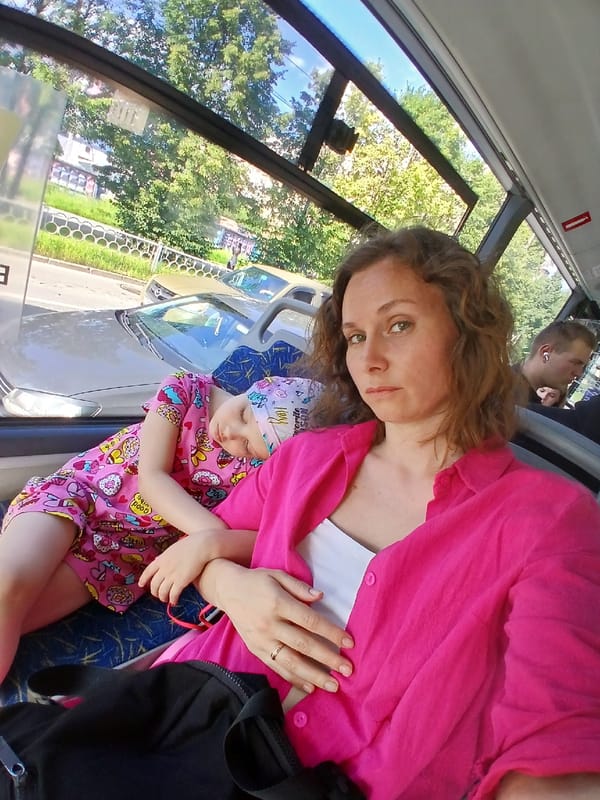 Selfie on a Yekaterinburg bus, child asleep in lap