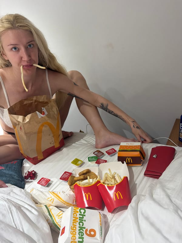 Woman eating McDonald's on hotel bed in Istanbul
