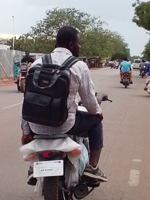 Motorcyclist travels through Tamale streets in northern Ghana