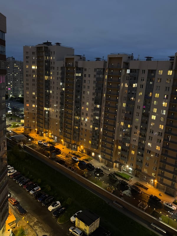 Evening lights illuminate Russian apartment buildings at dusk