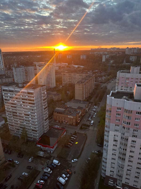 Sunrise observed over Khimki cityscape with dense clouds