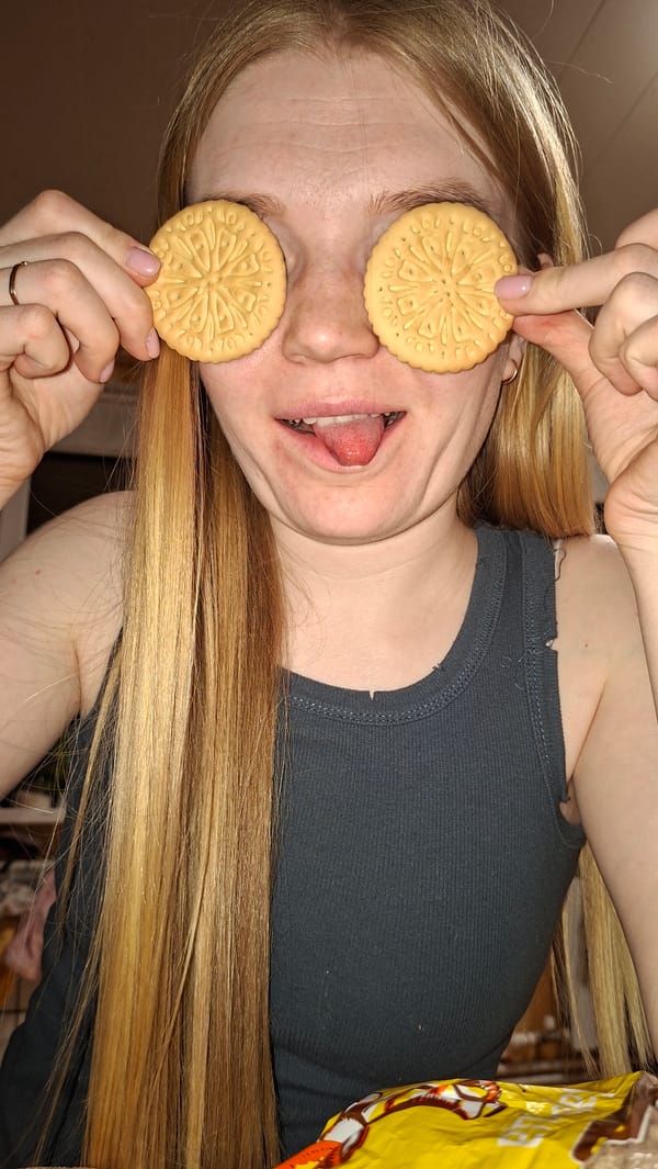 Woman poses playfully with cookies and fairy lights in Russia