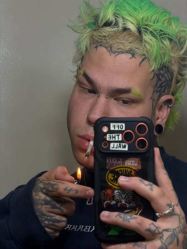 Tattooed person takes selfie while smoking in Ushuaia