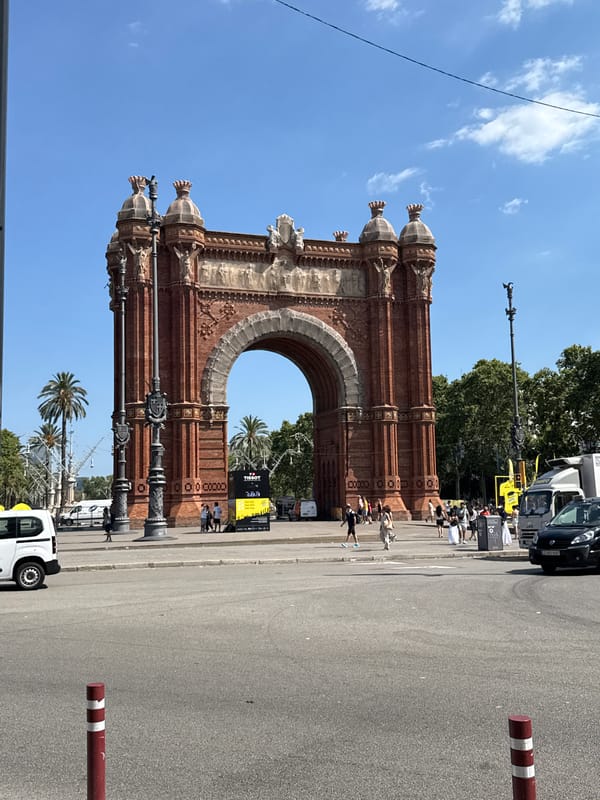 Arc de Triomf, Tour de France flags, and preserved fruits in Barcelona