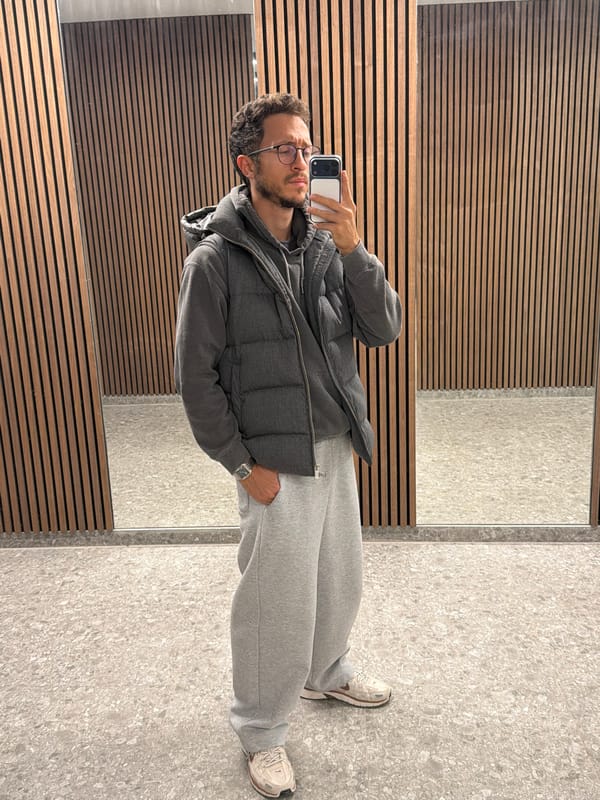 Man takes mirror selfie in gray outfit in Larnaca