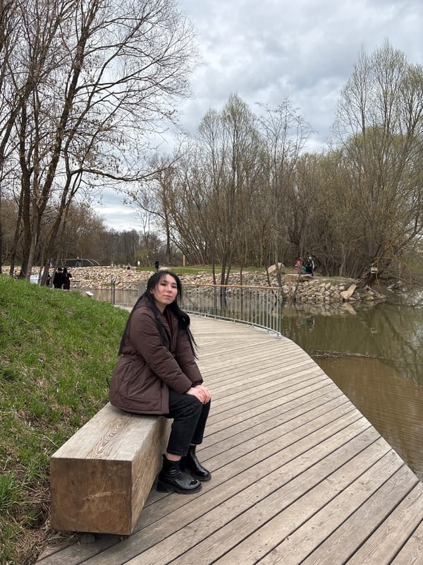 Young woman visits waterfall park in Kazan during spring