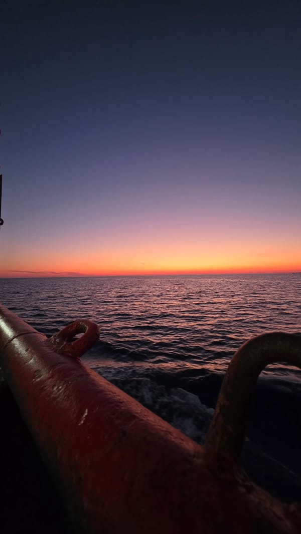 Orange sunset observed from boat off Greek coast