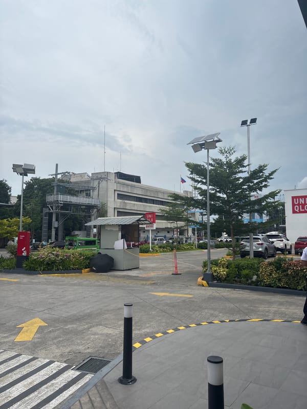 Street-level look at a Jollibee and surrounding retail strip in Davao City