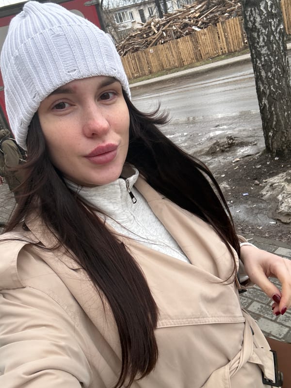 Person in layered winter clothing photographed in selfie-style shot