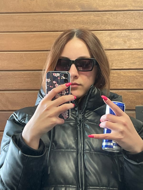 Woman takes selfie against wood wall in Sofia
