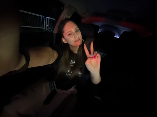 Woman takes selfie with peace sign in Bulgarian vehicle